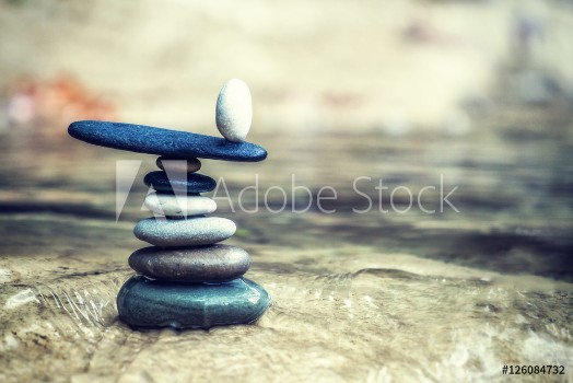 Bild på Rock Zen Stack in front of waterfall
